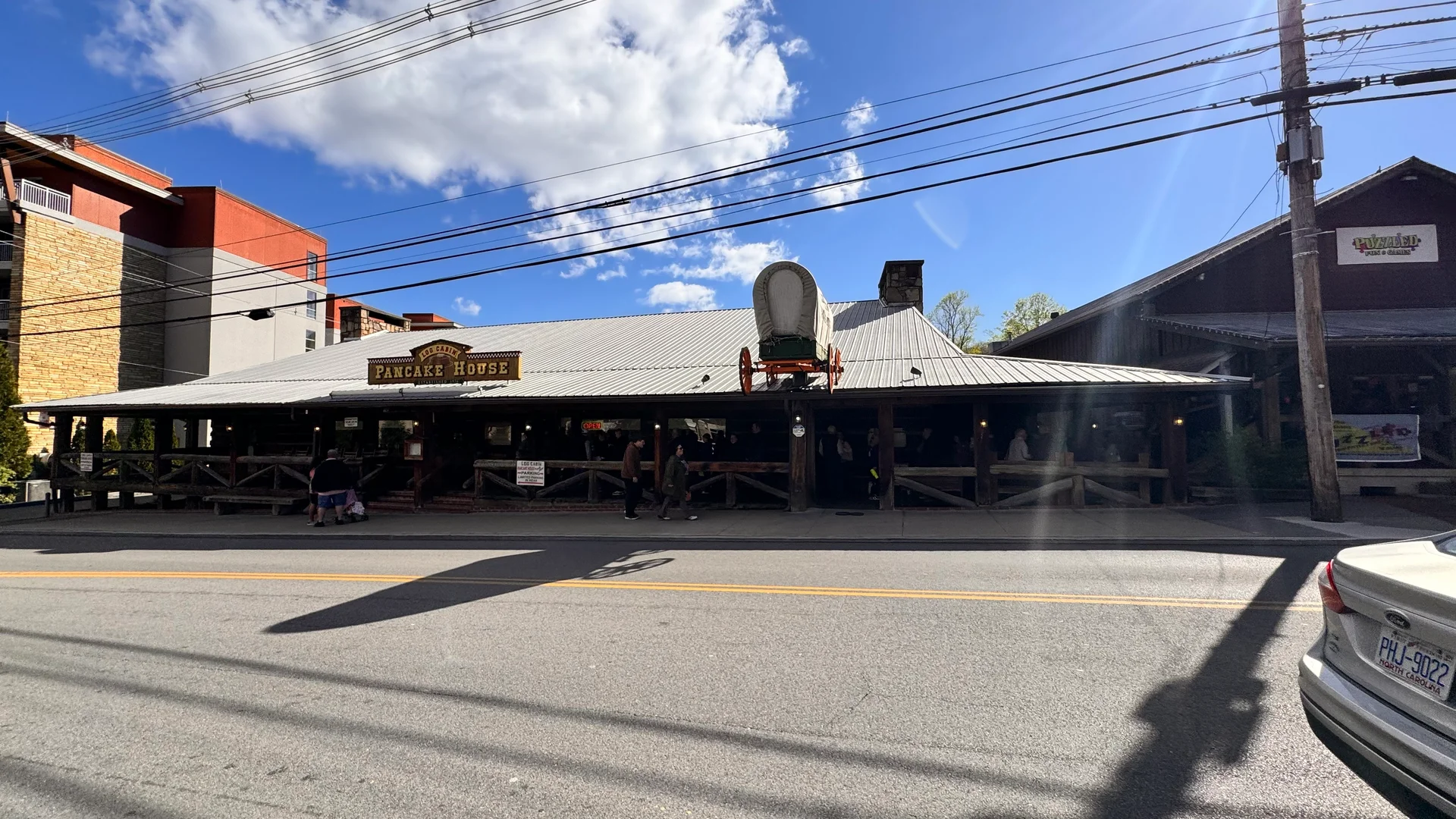 Log Cabin Pancake House's rustic exterior with a covered wagon on the roof in Gatlinburg