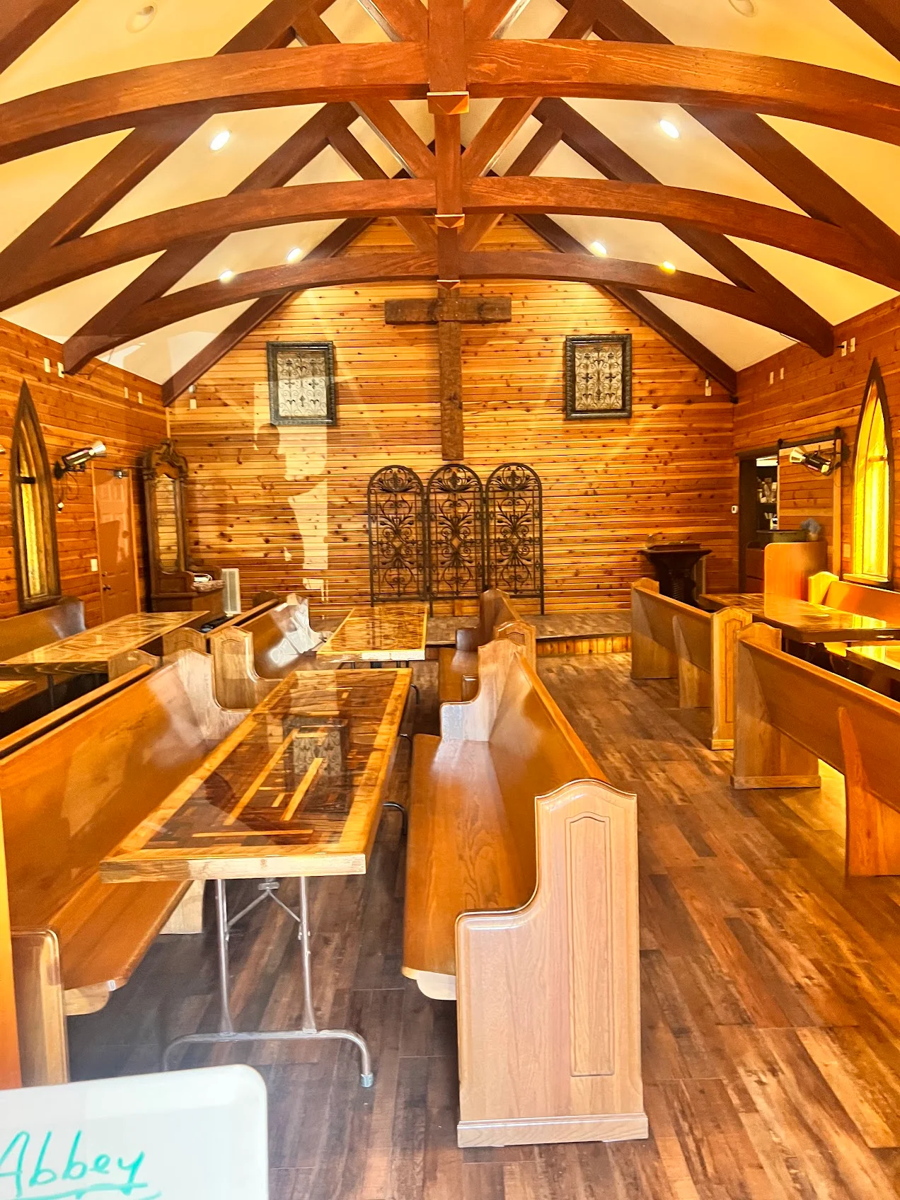 Rustic wedding chapel interior with dark wood arched beams, Gatlinburg